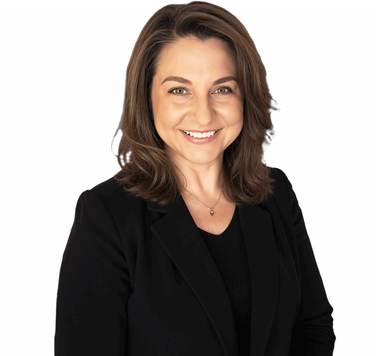 A woman with shoulder-length brown hair, wearing a black blazer and top, smiles while facing the camera against a plain background.