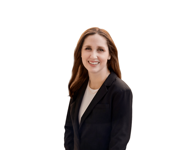 Woman with long brown hair wearing a black blazer and white top, smiling, posed against a plain white background.