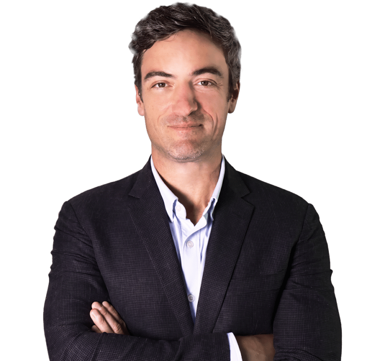 Eric Atlas, managing director at Encore Finance, stands with arms crossed in a dark suit jacket and white shirt, facing the camera against a plain white background.