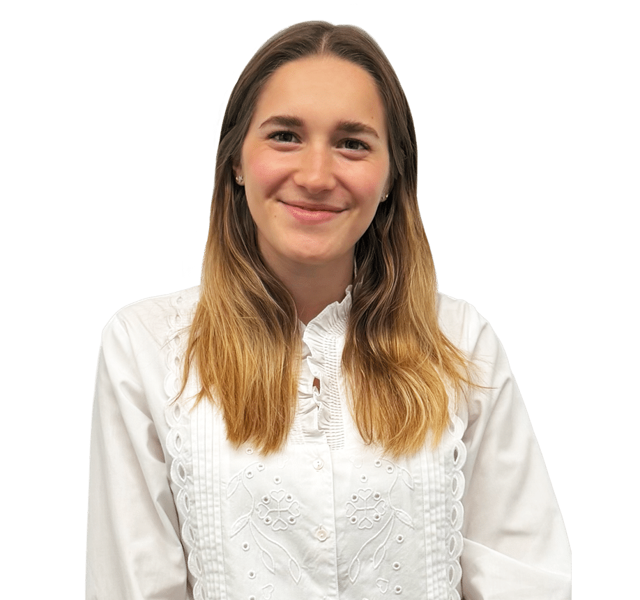 A person with long, light brown hair, wearing a white embroidered shirt, smiles at the camera against a plain white background.
