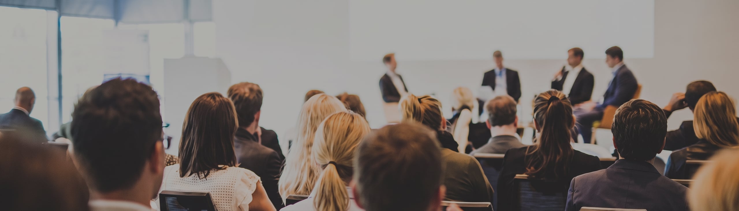 Audience members sit facing a panel of four people speaking at the front of a conference room, where the discussion centers on how BFR Is Becoming More Selective. Here’s What That Means for the Market—a topic generating keen interest and insightful questions from attendees.